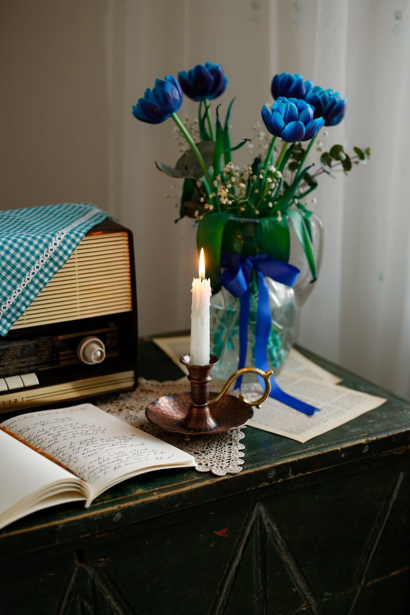 A quiet still life — flowers and a candle in low light